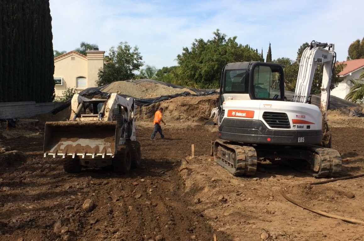 Excavator moving earth during site preparation