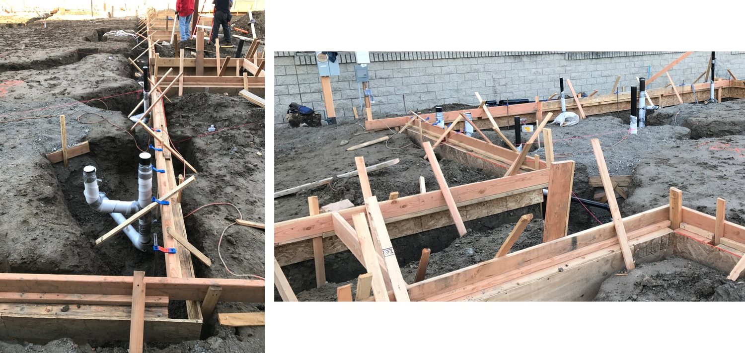 Underground plumbing and foundation formwork with reinforcing steel before the pour