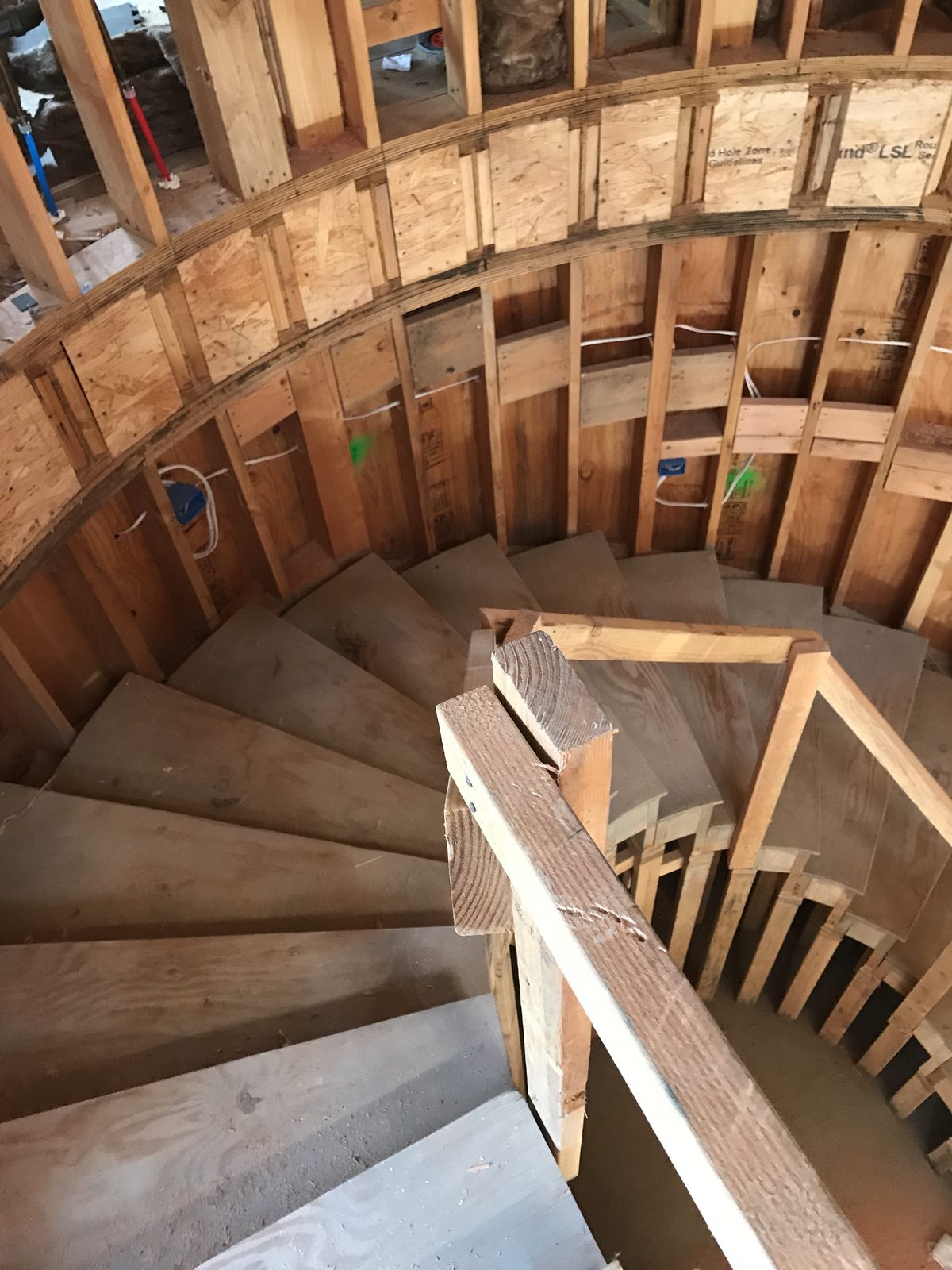 Custom curved stair framing and subfloor construction by Newport Construction Group